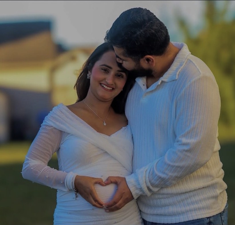 Maternity couple sharing a quiet moment outdoors